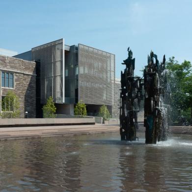 Fountain of freedom and wading pool in foreground, Louis A Simpson International building in background.