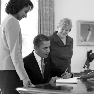 President Barack Obama signs the Economic Report of the President in the Oval Office
