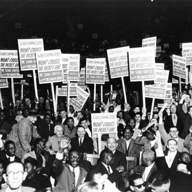 Workers are seen holding signs that read: "The Dress Shipping Clerks' Won't Cross the  	Picket Line. We Stand United with the Dressmakers Union” Photo from 1958.