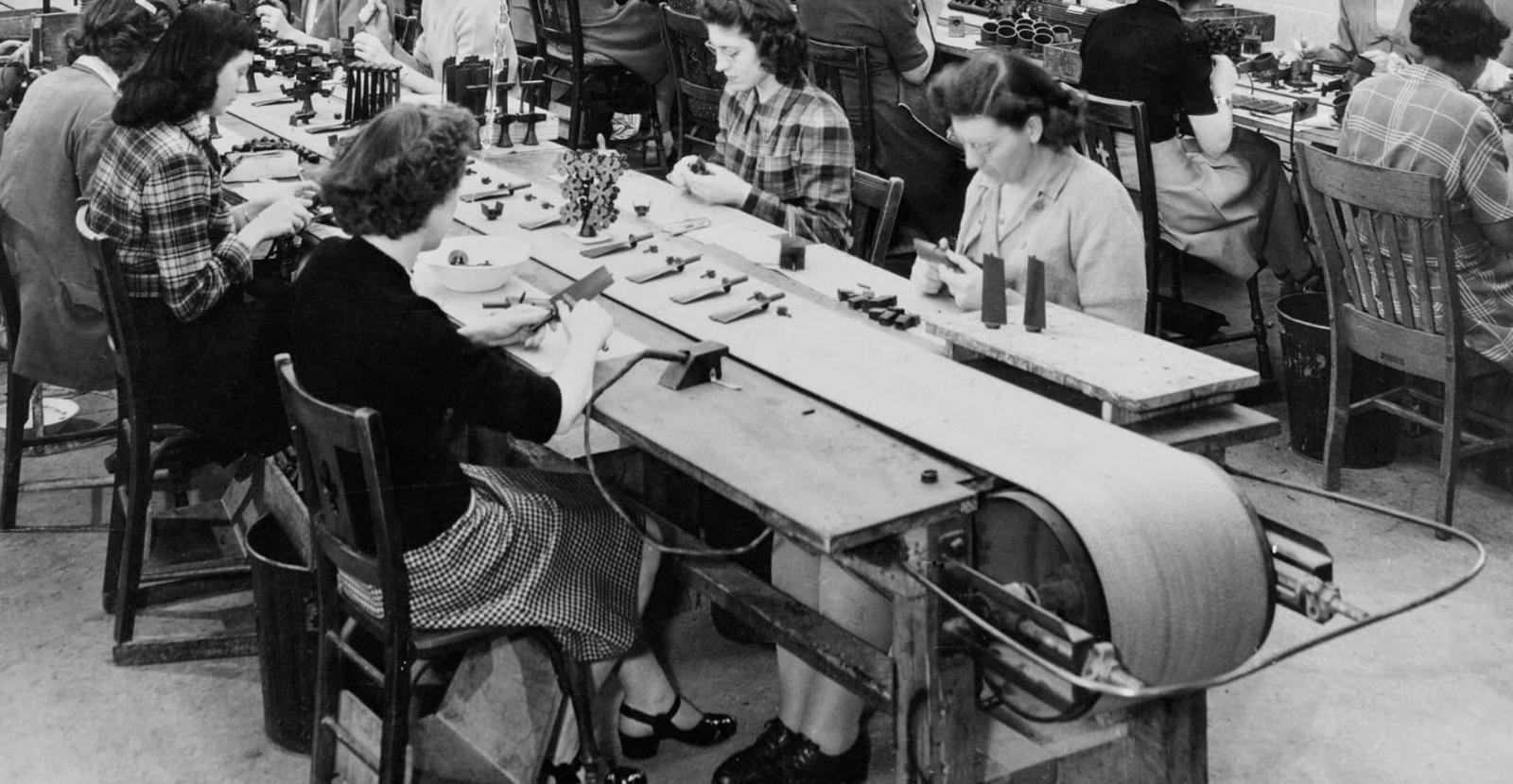 Women at work, sitting at assembly table in 1940s