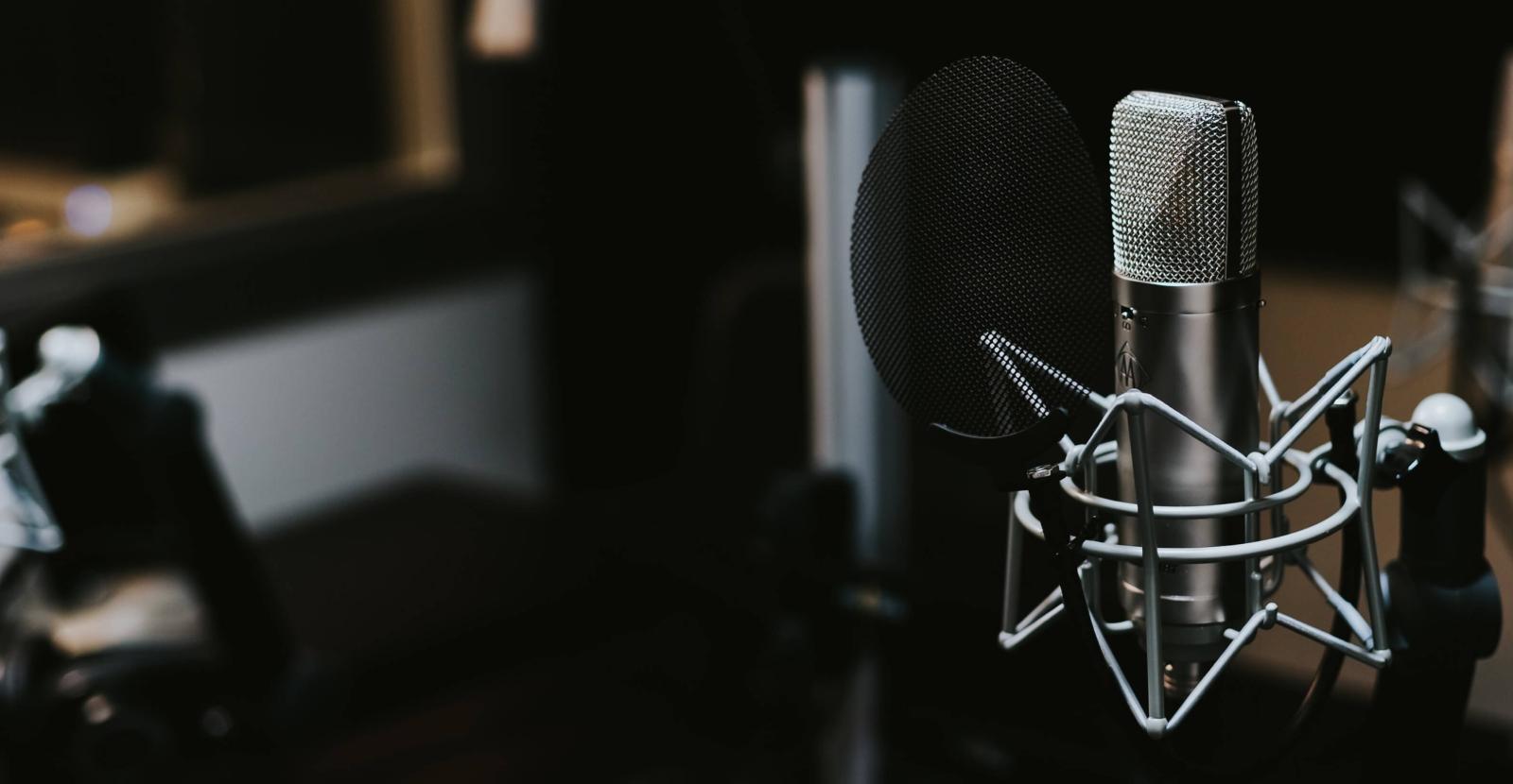 Microphone on right in a dark recording studio