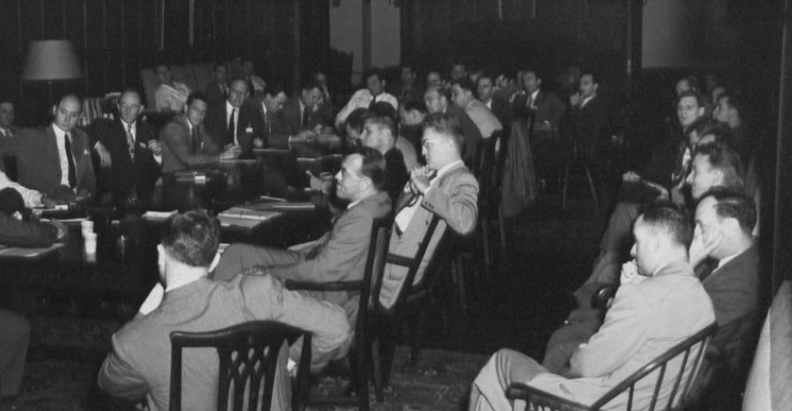 Men sitting at and around conference table, Industrial Relations Conference 1947