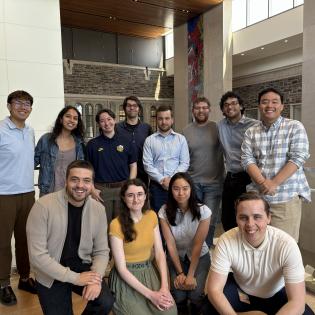 12 predoctoral research assistants pose for a group photo in the Louis A Simpson International Building.